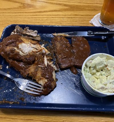A tray holding a half-eaten meal with a fork resting beside it.