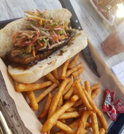 A sandwich and a side of French fries served on a tray.
