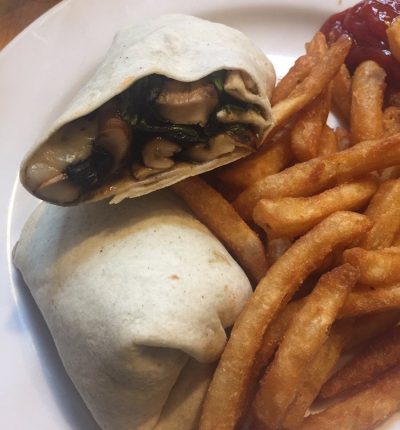 A plate featuring a burrito alongside a serving of golden fries.